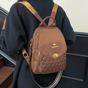 Brown nylon backpack with diamond quilting and gold kangaroo logo shown on model