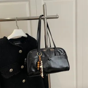 Retro black leather shoulder handbag with vintage glossy finish and wooden bead charm