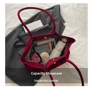 Internal view of the large red suede tote bag showing capacity for daily essentials