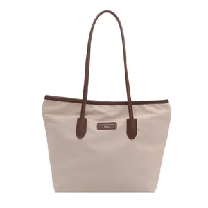 Large capacity beige nylon tote bag with brown leather handles for commuting and travel