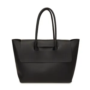 Minimalist black leather tote bag for women with dual handles and unique flap design