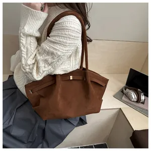Detail of caramel frosted leather tote bag with elegant handle and buckle