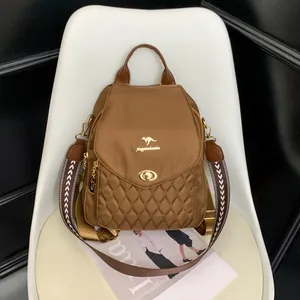Detail of dark brown quilted backpack with kangaroo logo and ethnic patterned strap