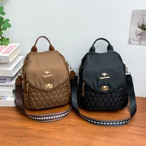 Detail view of stylish quilted nylon backpacks featuring gold logo and patterned straps