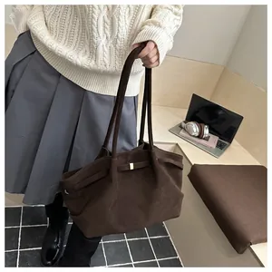 Retro large brown matte suede tote bag shown on a wooden desk with a laptop and headphones