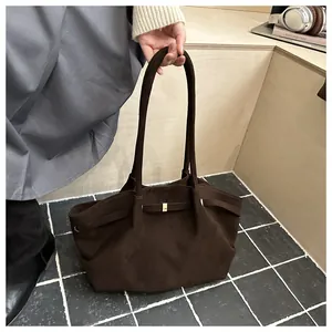 Detail of vintage matte brown suede tote bag with long handles and golden metal buckle