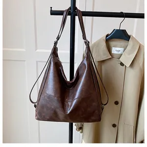 Macro detail of dark brown leather tote bag texture and zipper closure on trench coat