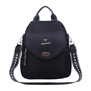 Chic black quilted backpack for women with golden kangaroo logo and patterned strap