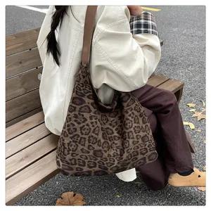 Fashionable leopard print tote bag with leather strap styled in an autumn outdoor setting