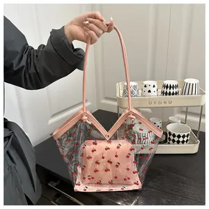 Detail of transparent PVC tote bag with cherry print and pink inner pouch set