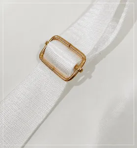 Detail of adjustable white strap with premium gold metal buckle for luxury backpack