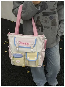 Close-up of a multi-pocket cream tote bag with pink straps and colorful pastel compartments