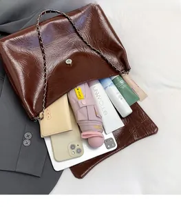 Detailed interior of dark brown tote bag showing large capacity for laptop and umbrella