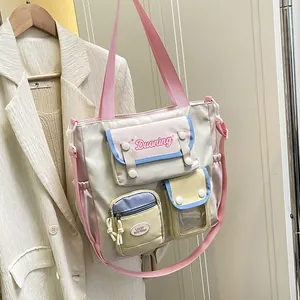 Multicolor canvas school bag with multiple pockets and adjustable pink shoulder strap