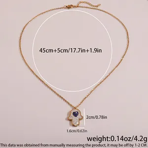 Detail of Hamsa necklace with blue heart and dimensions 45+5cm length and 4.2g weight