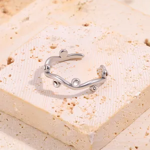 Close-up of irregular wavy silver ring with sparkling micro-set clear zircons