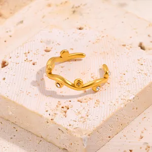 Detailed view of an adjustable gold vine ring with inlaid clear cubic zirconia stones