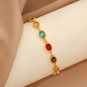 Elegante pulsera de acero inoxidable dorado con circonitas de colores corte ovalado