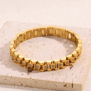 Detailed shot of golden stainless steel flower pattern watch-style bracelet on stone