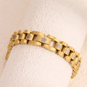 Detailed close-up of golden stainless steel flower bracelet with watchband chain link