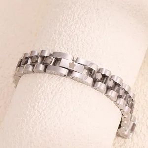 Detailed close-up of a silver stainless steel chain bracelet with floral pattern links