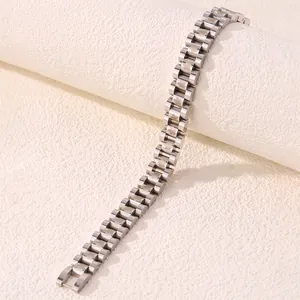 Detailed macro of stainless steel watchband-style bracelet with carved flower links