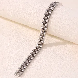 Macro shot of silver stainless steel strap bracelet featuring engraved floral patterns