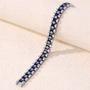Detail of titanium steel bracelet featuring silver links with blue flower strap charms