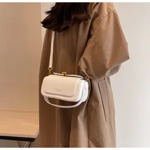 Close-up of a white leather doctor-style crossbody bag with embossed fashion text detail