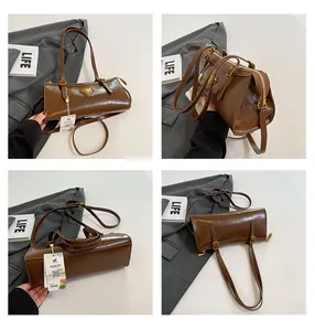 Detailansicht der braunen Vintage-Boston-Tasche mit Metalllogo und mehreren Perspektiven