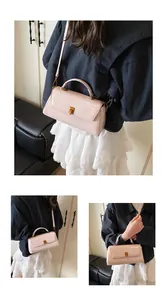 Detail of light pink patent leather mini square bag with golden twist lock and top handle