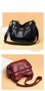 Detail of lychee textured leather crossbody bag showing dual zippers and side pockets