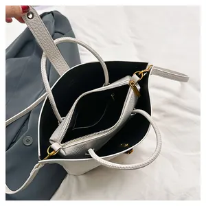 Detail of white lychee leather tote bag interior with a matching removable pouch