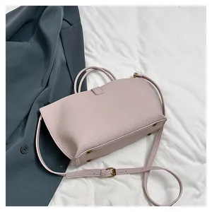Close-up of light purple lychee grain leather tote bag with elegant gold hardware details