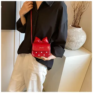 Détail d'un mini sac rouge avec un nœud 3D et des motifs à pois blancs élégants