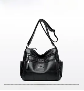 Close-up of black lychee texture leather shoulder bag featuring multiple zipper pockets