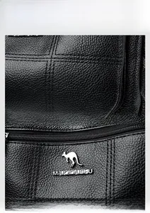 Detail of black lychee grain leather texture with silver metal kangaroo logo and zipper