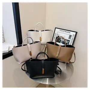 Close-up of tote bags in four colors with lychee grain leather and gold metal buckle