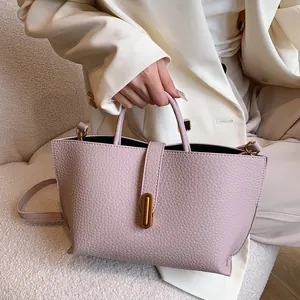 Elegant lavender lychee leather tote bag with gold buckle and adjustable strap for women