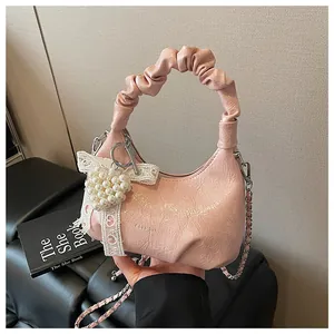 Pink crescent cloud bag detail with pearl heart charm and white lace bow decoration