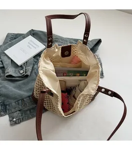Detailed interior of large woven tote showing spacious storage with inner zip pocket