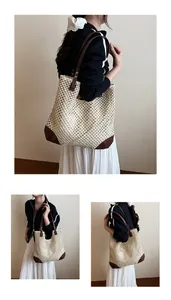 Detail of hand-woven straw tote bag with brown leather base reinforcement and shoulder straps