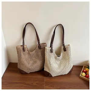 Detail of hand-woven straw tote bags with leather handles for summer beach vacations