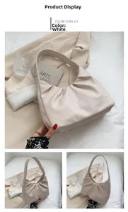 Macro detail of creamy white pleated leather hobo bag with soft textured aesthetic finish