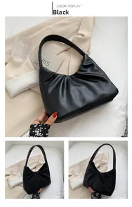 Detail of black pleated cloud bag with soft PU leather texture and zip closure