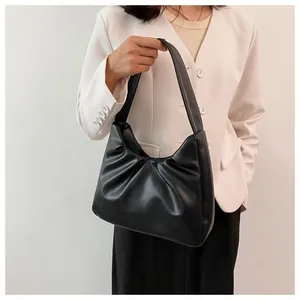 Detailed view of the black pleated cloud bag with a soft faux leather vintage texture