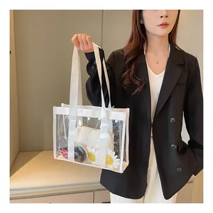 Detail view of transparent jelly tote bag with white canvas pouch and daisy ornament