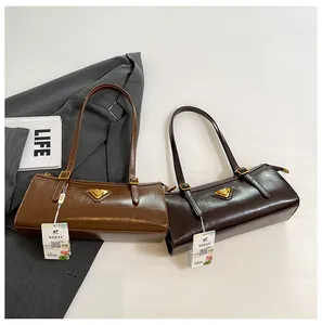 Detailansicht der rechteckigen Schultertaschen mit Glanzfinish und Metalldreieck-Beschlag