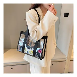 Detailed view of a clear PVC tote bag with black straps and internal daisy sunglasses