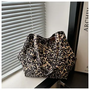 Detail of leopard print tote bag with outer pocket showing durable canvas texture